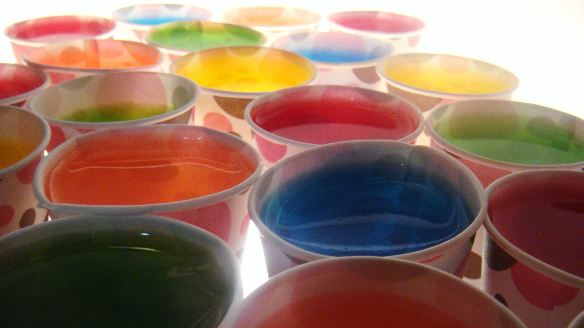 a bunch of cups full of paint sitting on top of a table