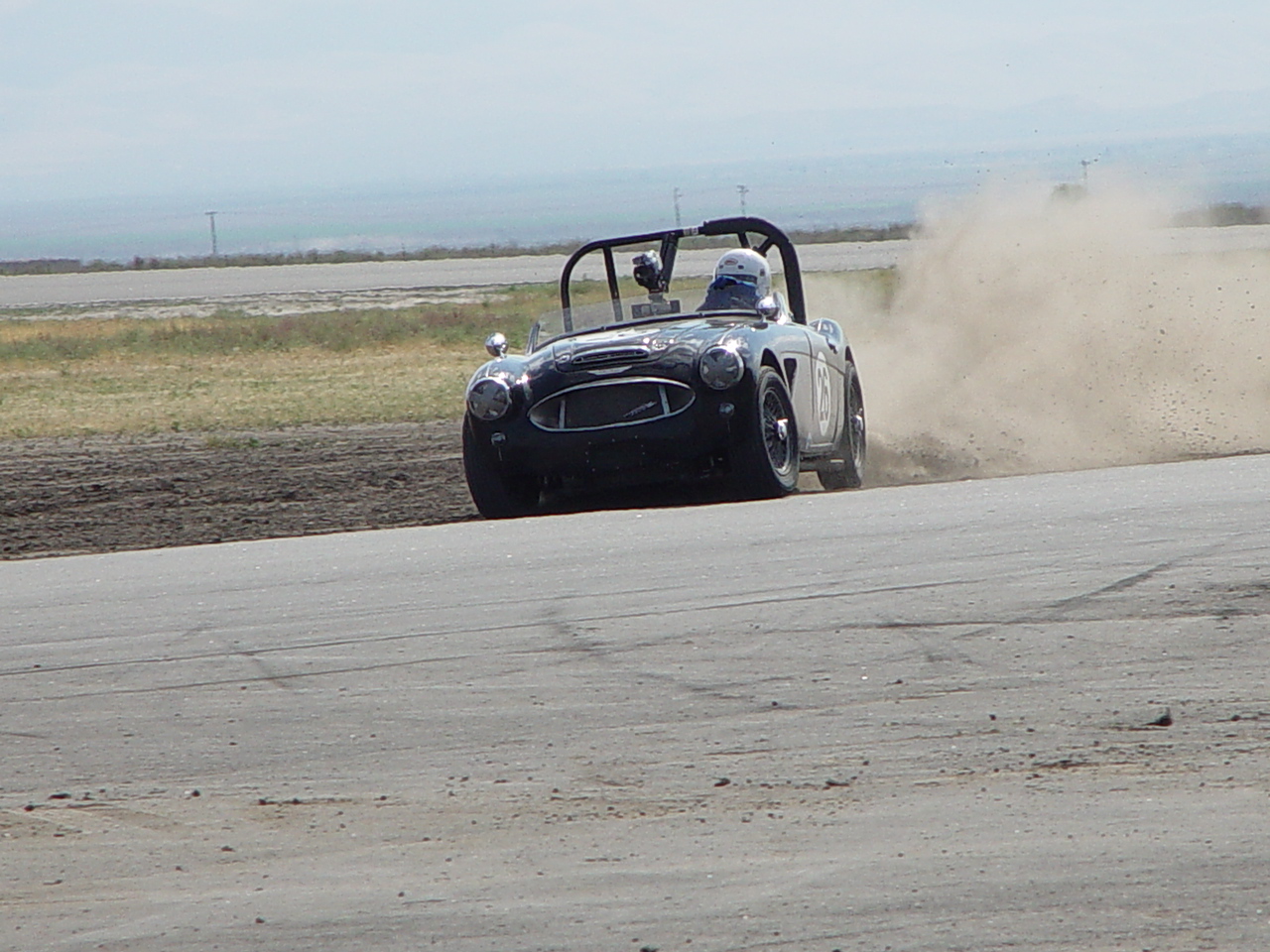 a buggy driving on an empty road in the desert