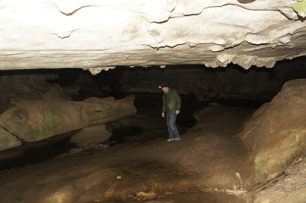 a person in a cave with an object in the foreground