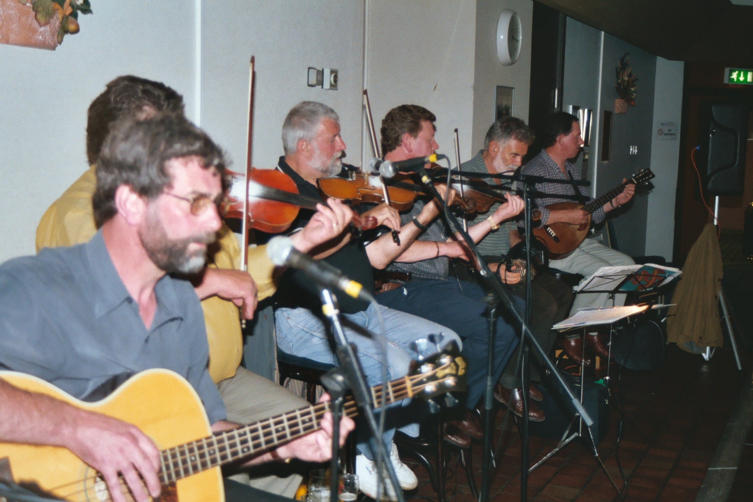a group of people with guitars and a microphone