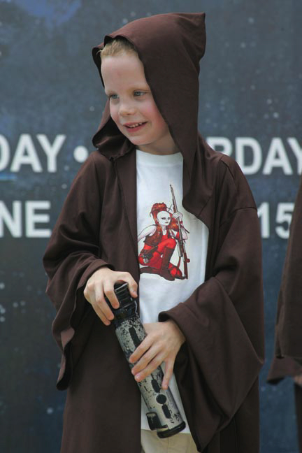 boy dressed in brown and white hoodie with a bottle