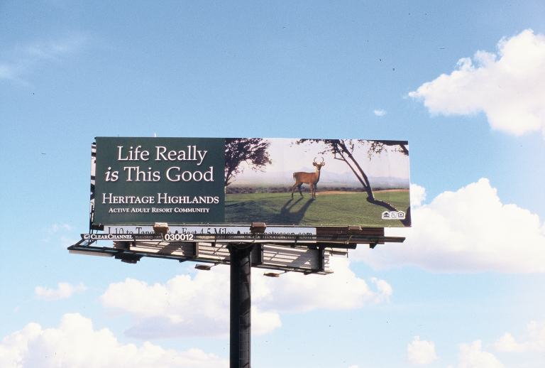 a sign with a deer is displayed in the sky
