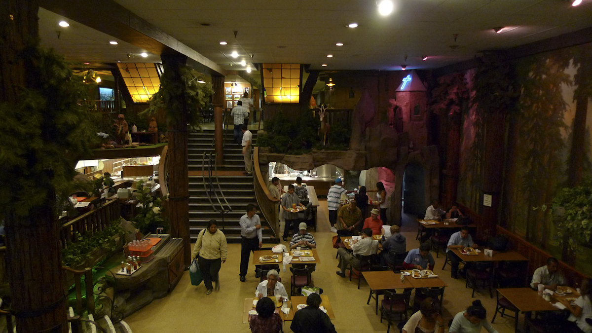 people are sitting at tables in a restaurant