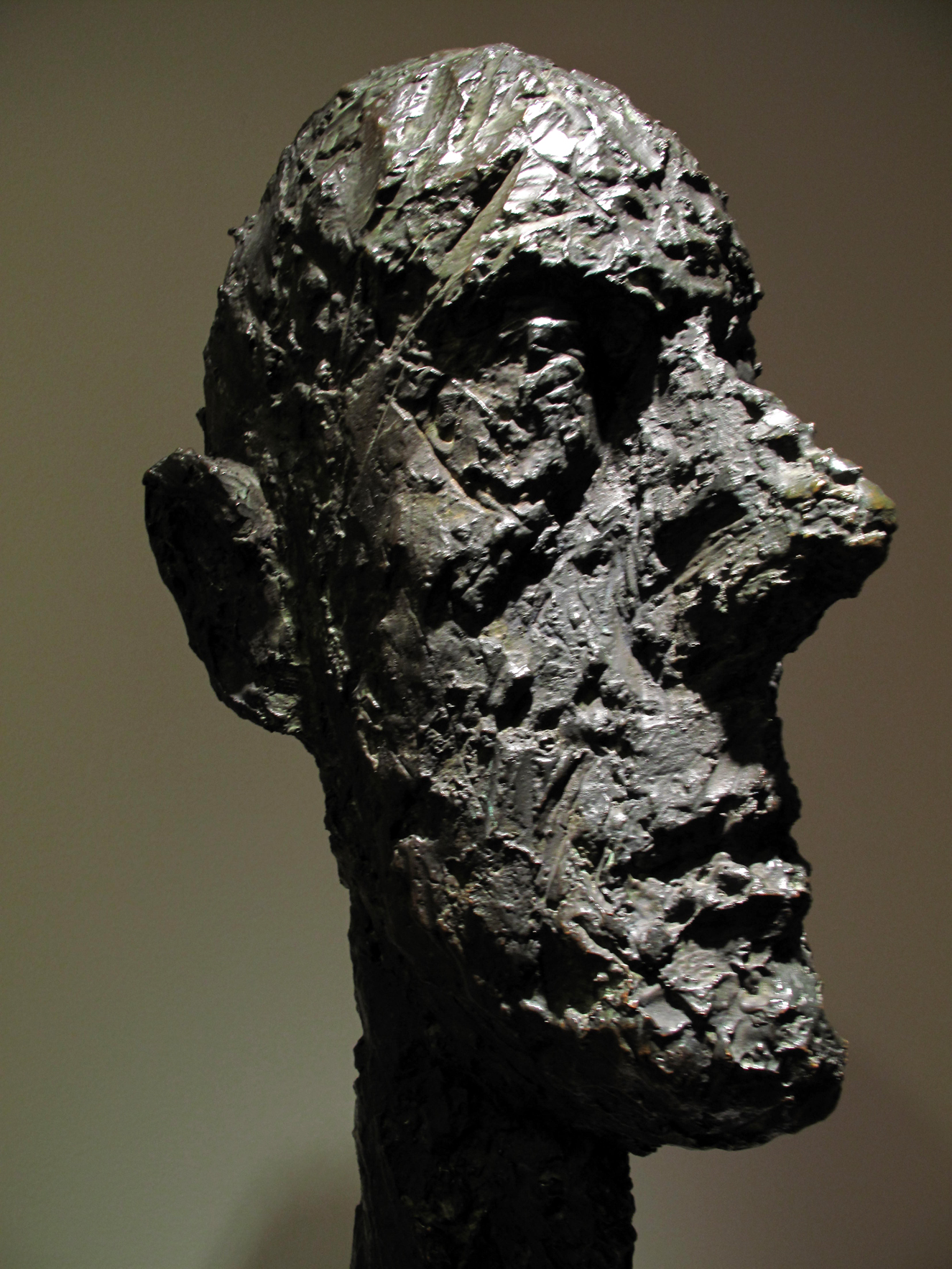 a black sculpture of a man is standing up