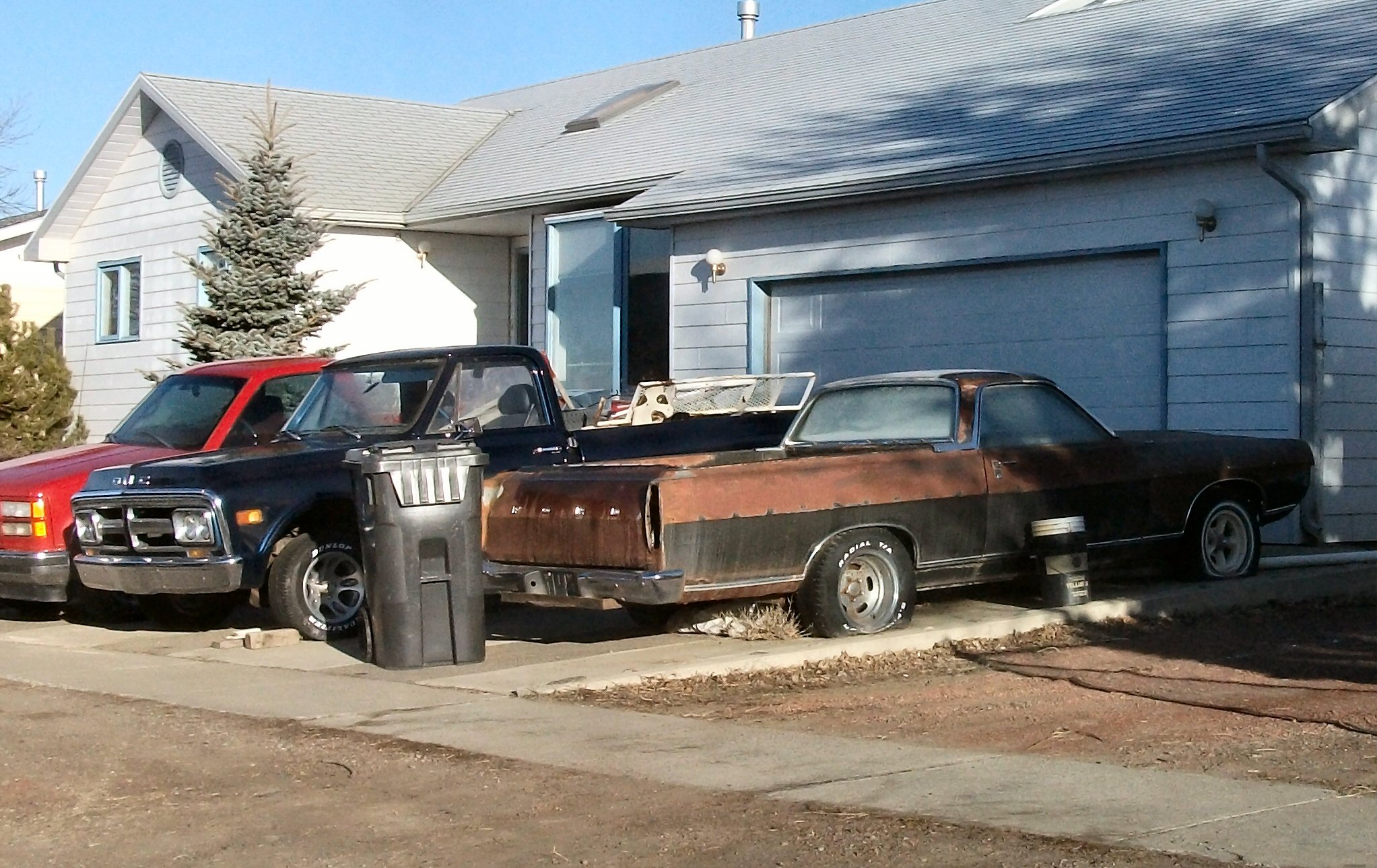 two trucks parked in front of a house