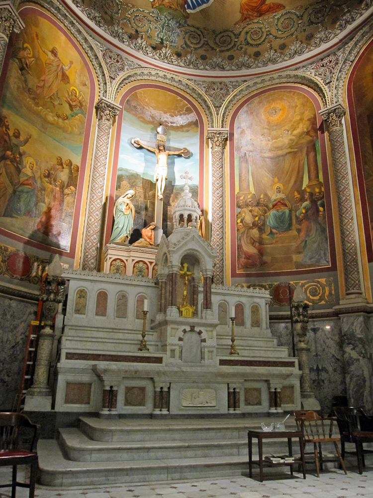 a large church with statues, paintings and a ceiling painted in gold