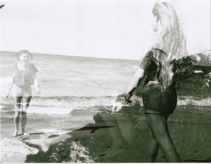 a man and a woman standing on the beach