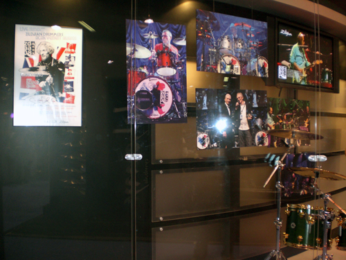 the display case includes several musical instruments and posters