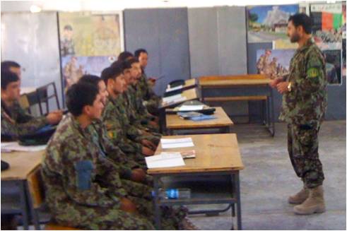 men in camouflage sitting at desks using computers