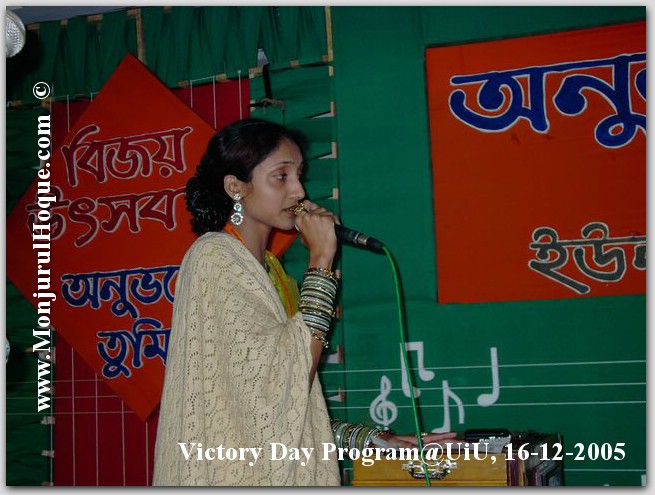 woman holding a microphone in front of an audience