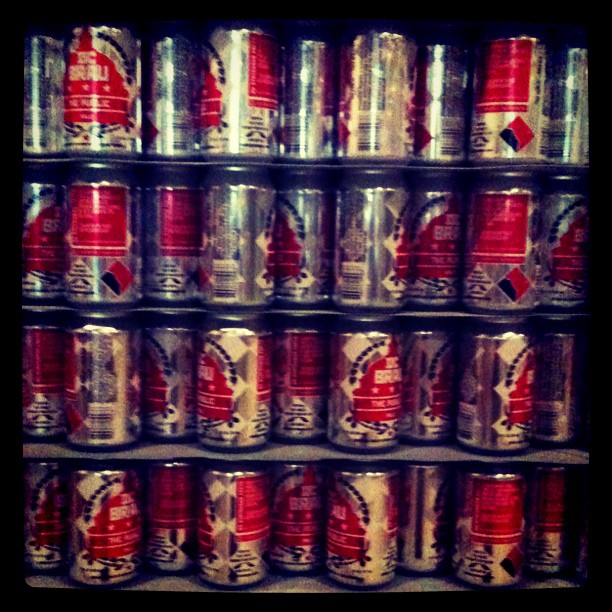 an assortment of cans in front of a shelf