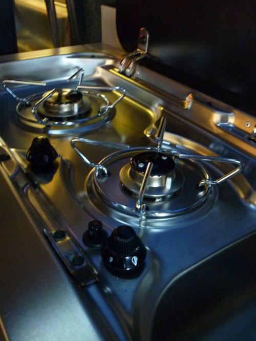 a gas stove that is very shiny with some chrome