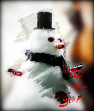 a white snow man wearing a top hat and scarf