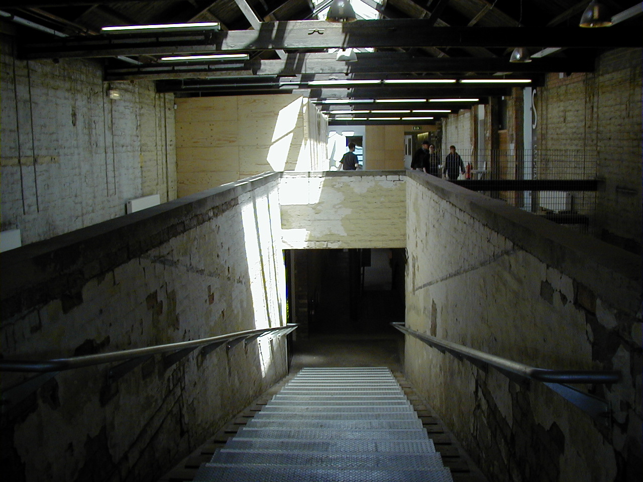 a long narrow staircase leading up to a ceiling in a building