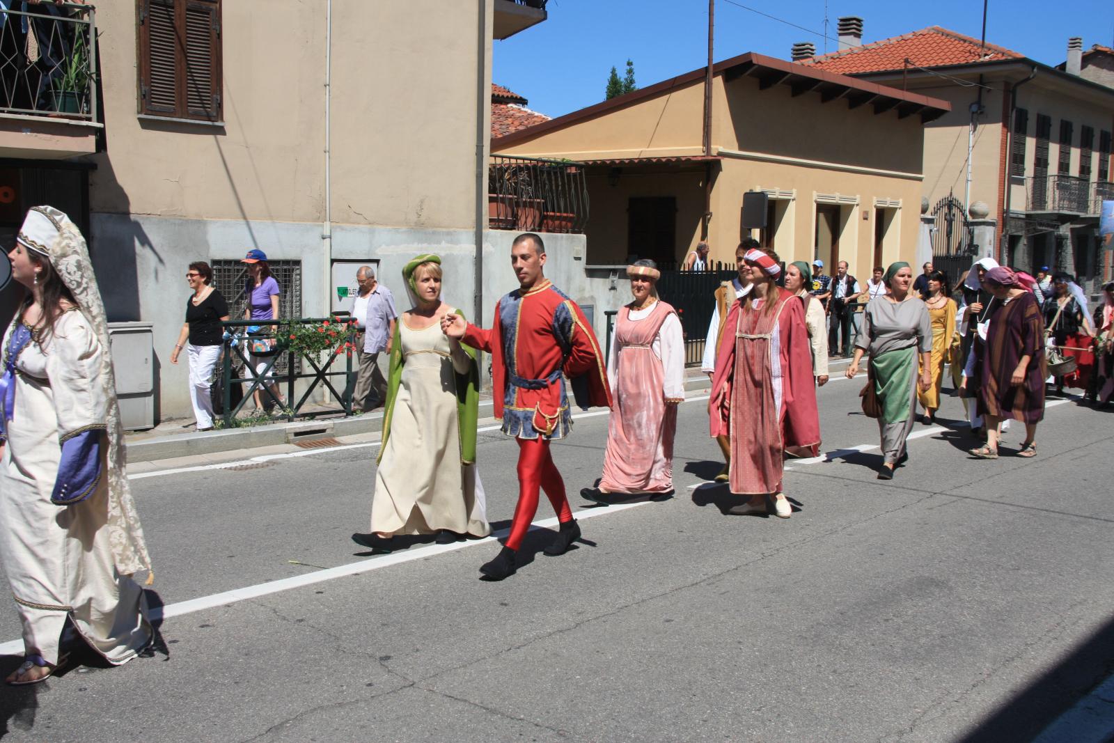 several people in costumes walking down the street