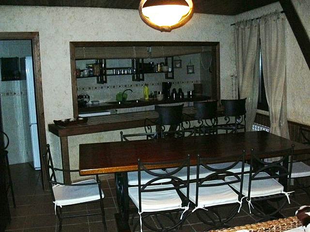 the kitchen has a table and chairs in it