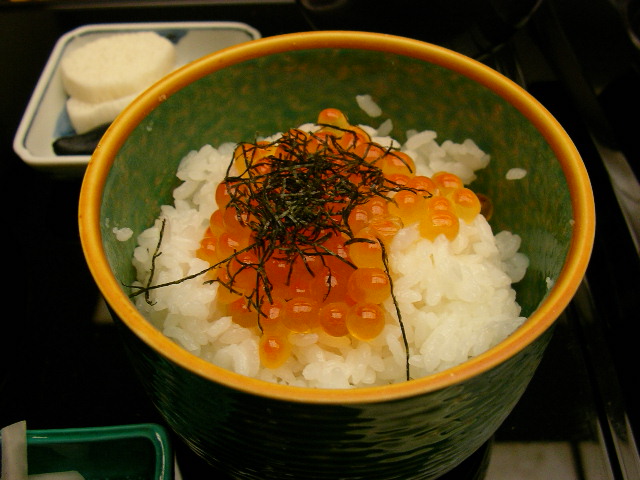 a bowl that has rice, seaweed and a few things
