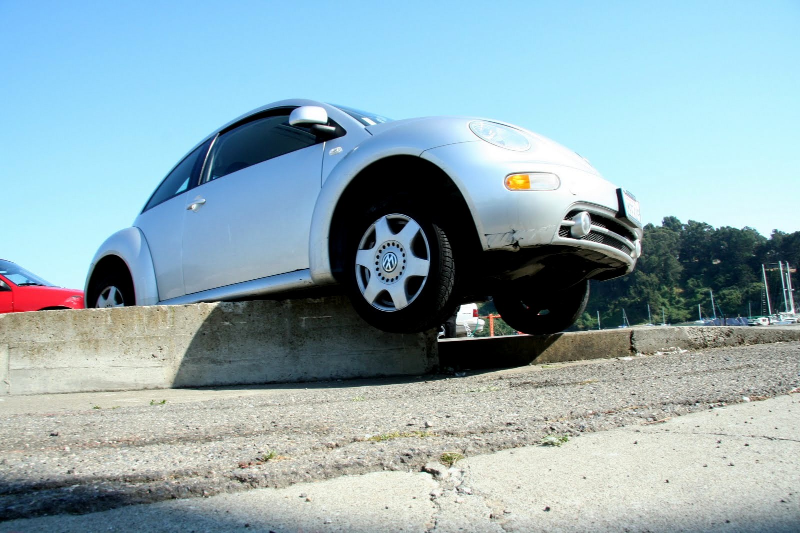 a white vehicle that has been lifted onto concrete