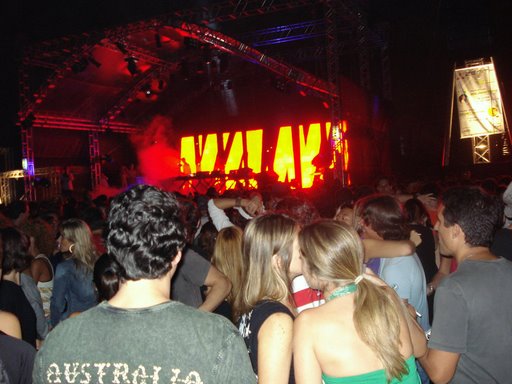 a group of people standing around in front of stage with fire