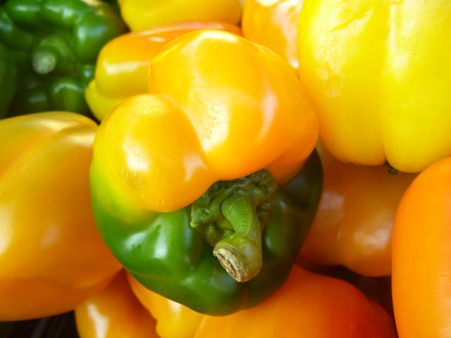 a large amount of orange and yellow peppers