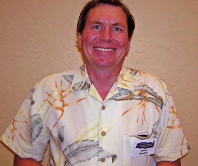 a man wearing an hawaiian shirt standing up