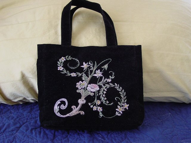 a black purse with embroiderywork design on it