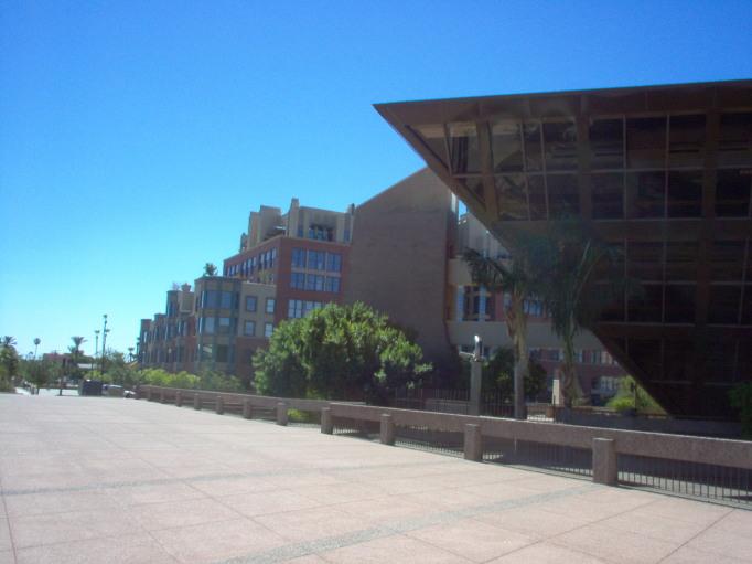 a view of a long and empty walkway outside of a building
