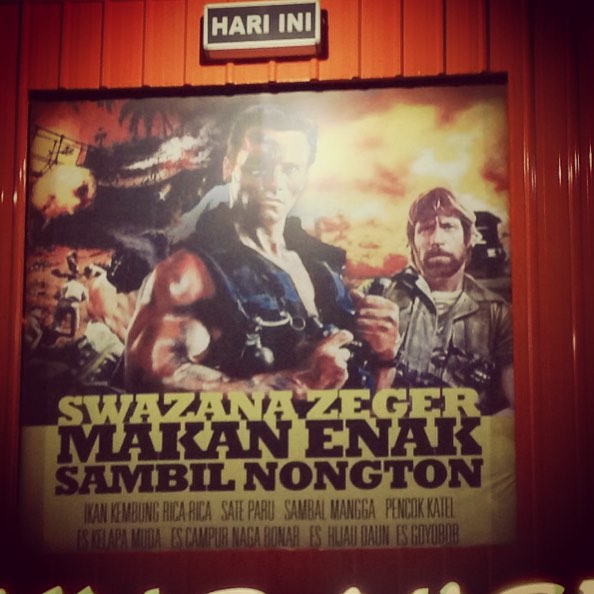 movie poster in large public building with advertit