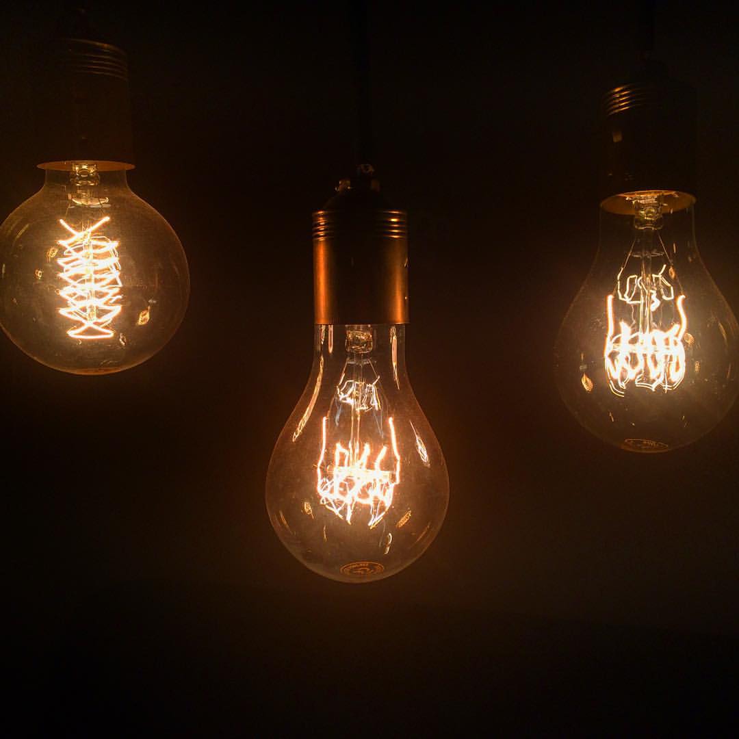 three light bulbs that are sitting on a wall