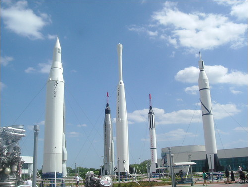several rockets are in a line near a building