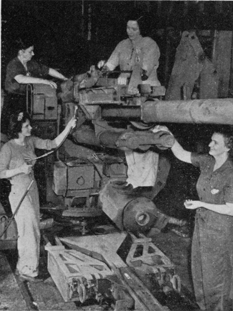 old black and white pograph of some people standing by an old tank