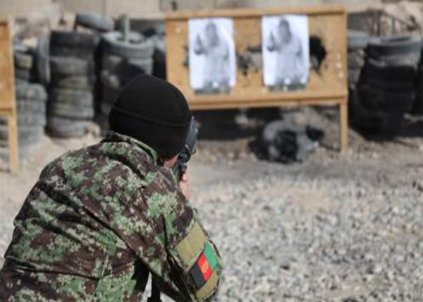 a soldier shooting a gun at an target