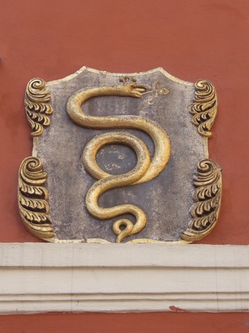 a golden metal plaque on the side of a building