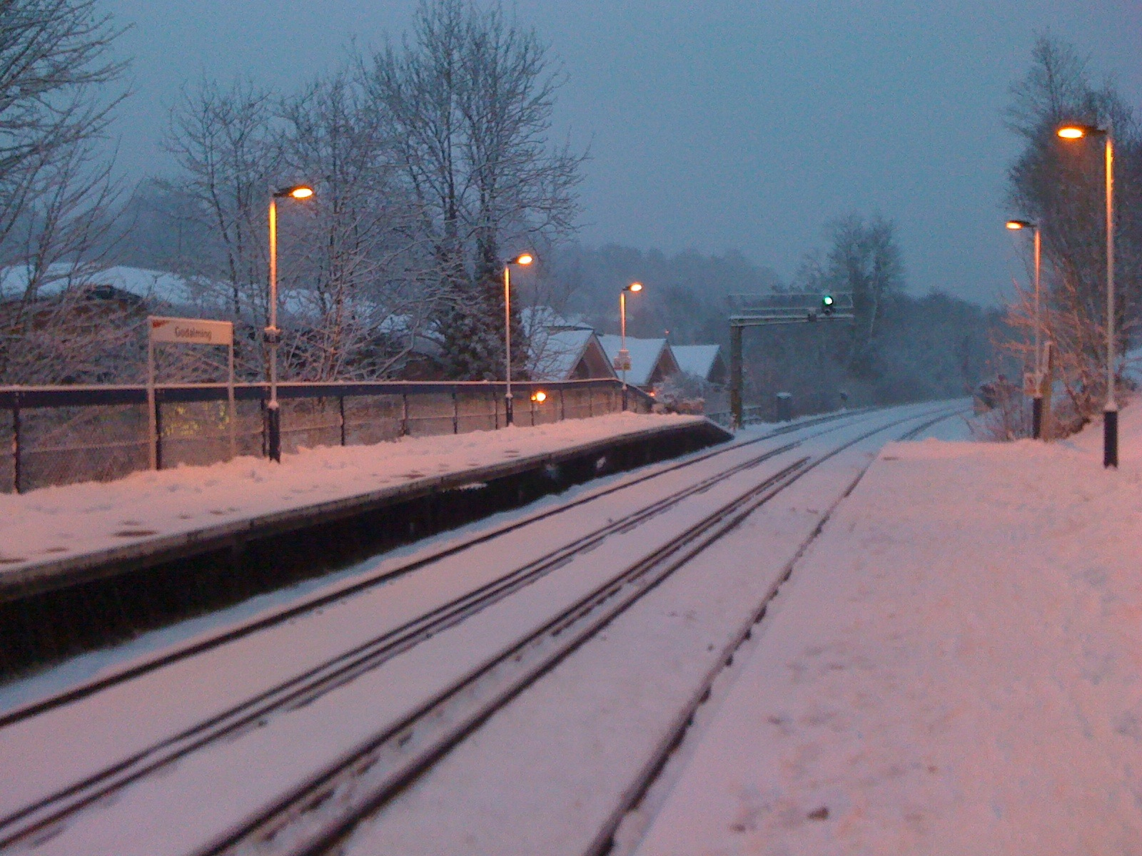 an empty platform at dusk in a wintery town