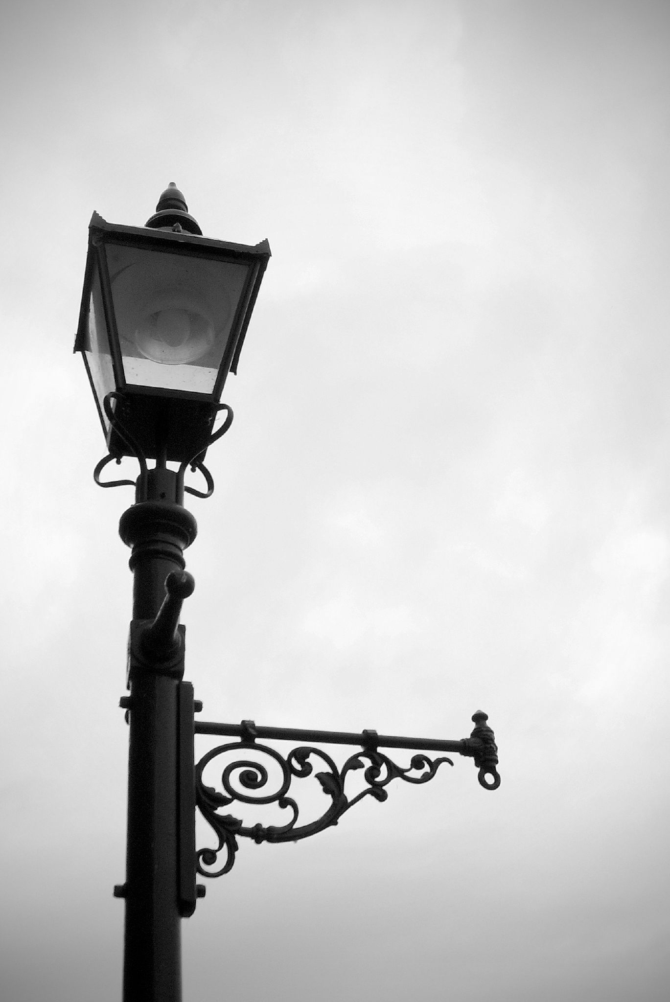 a black and white image of a lamp post