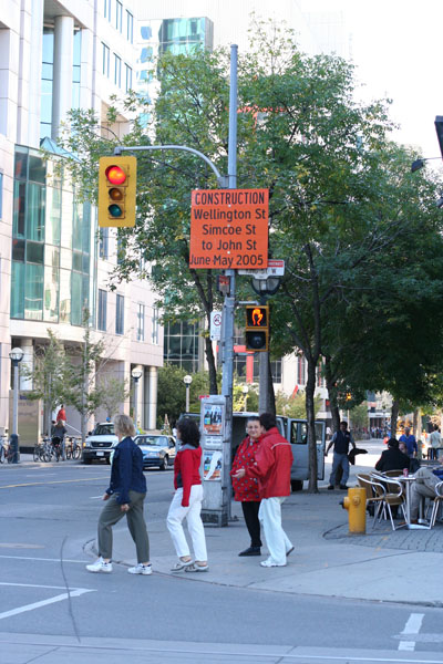 people standing near a traffic light on a city street