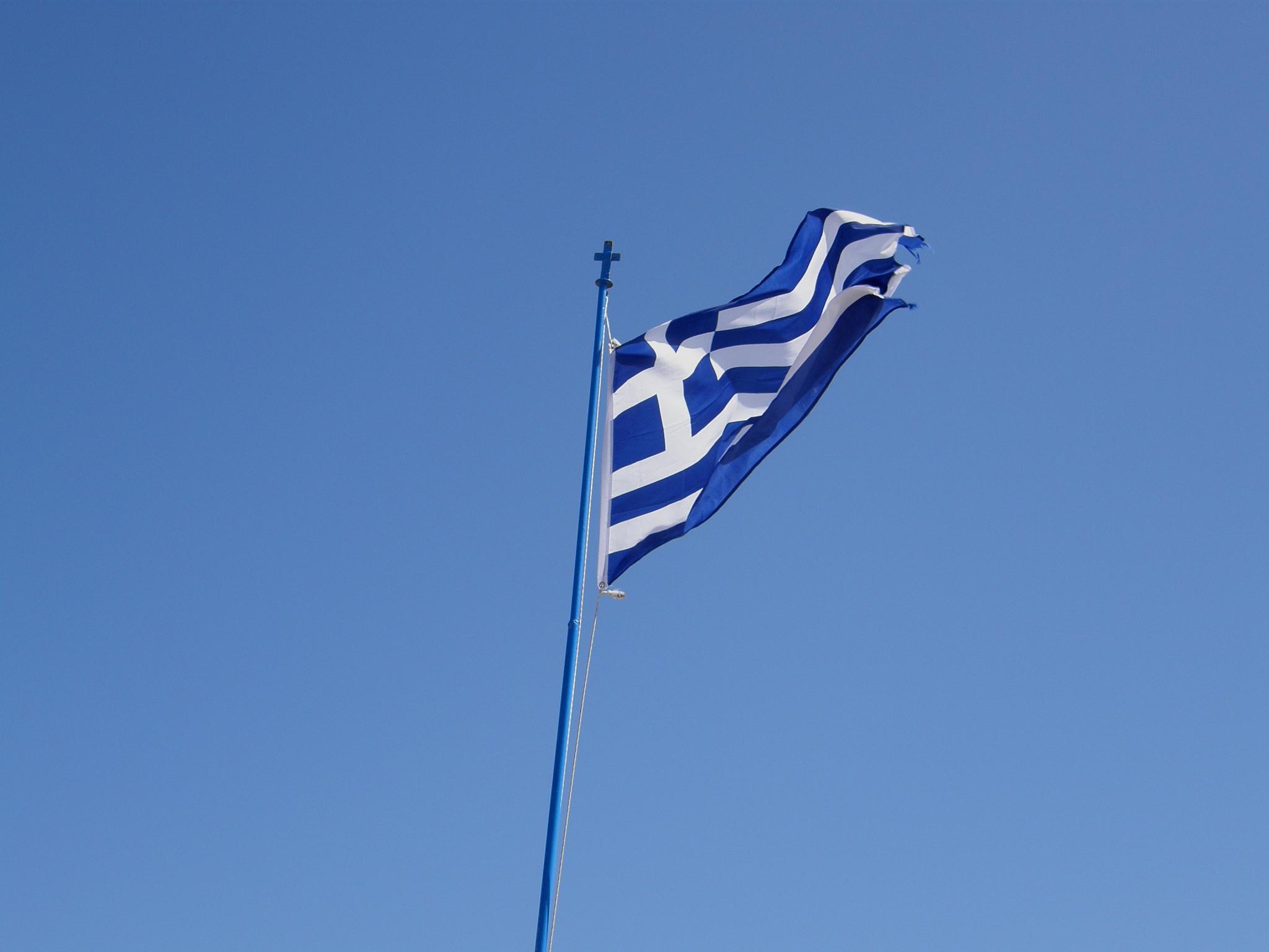 a tall blue and white flag on top of a pole