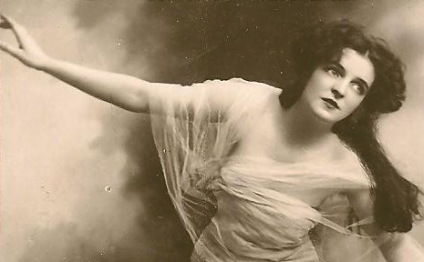 an old time po of a woman in evening dress with arms outstretched
