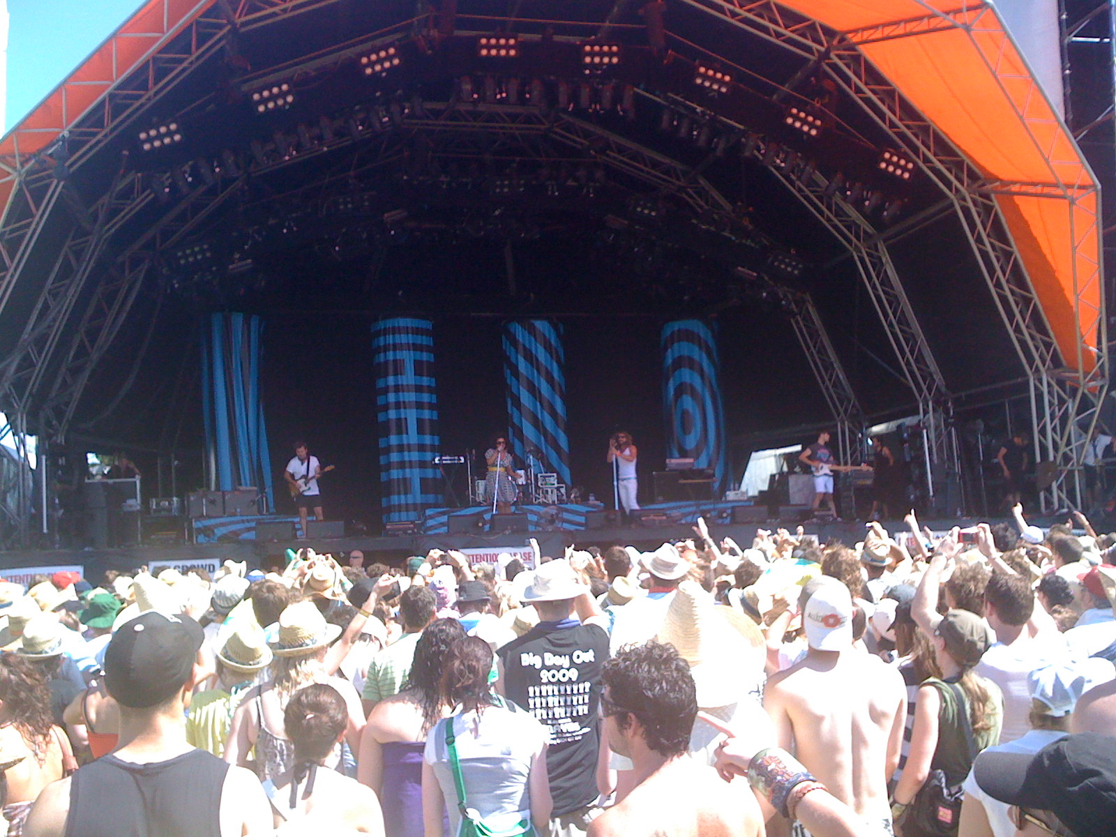 people on stage with bright lighting and one guy performing