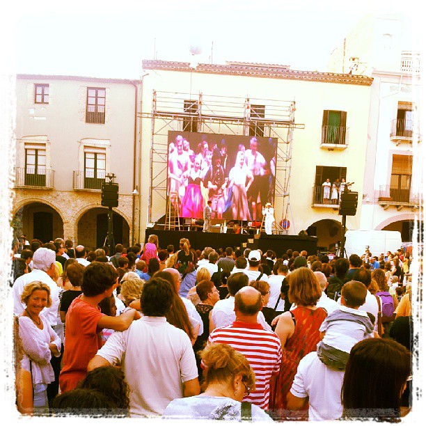 a crowd of people watching a concert on a stage