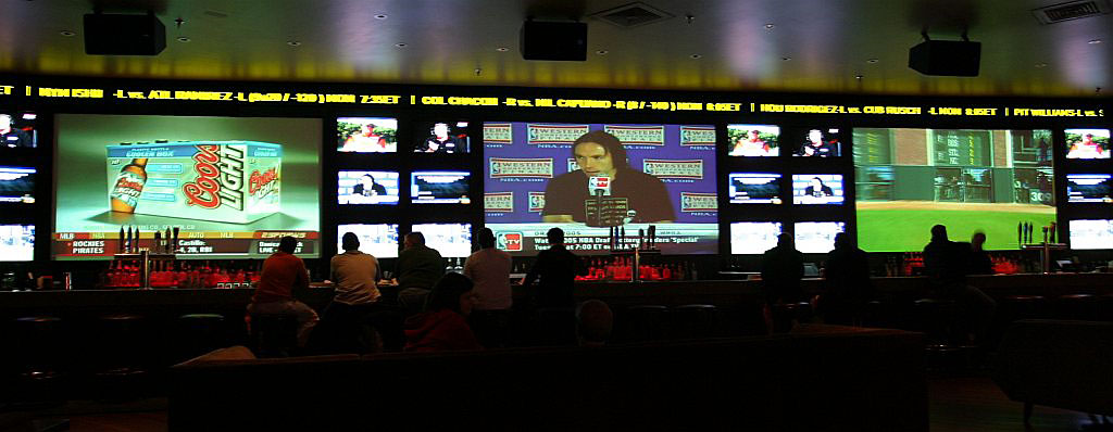 a large number of television screens in a room