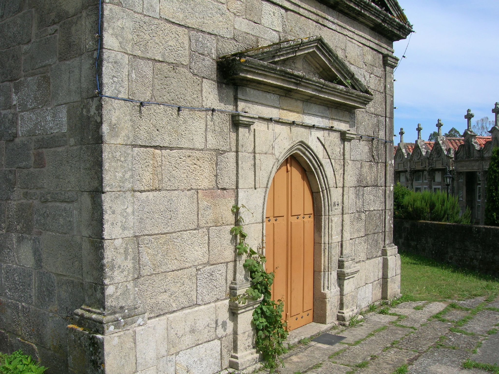 a tall gray stone building with a wooden door