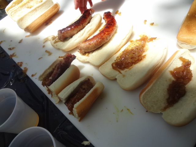 a white tray topped with cut up  dogs and buns