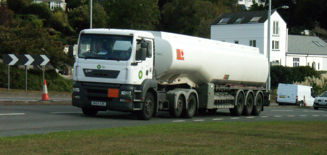 a large cement mixer truck travels down the road