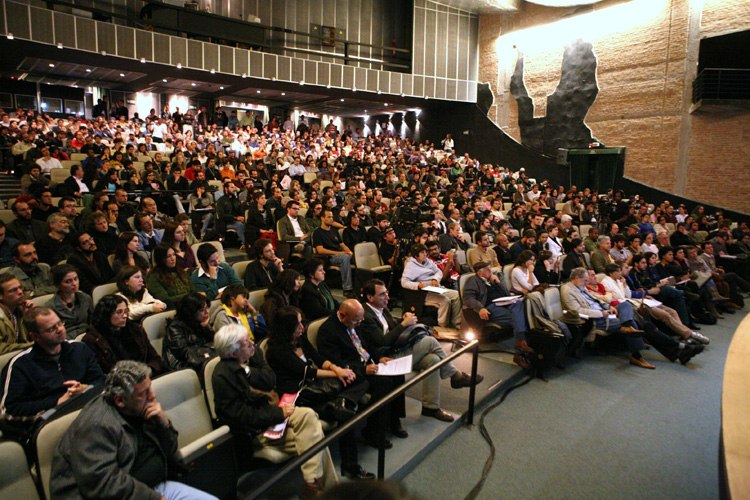 a full auditorium with people sitting in chairs