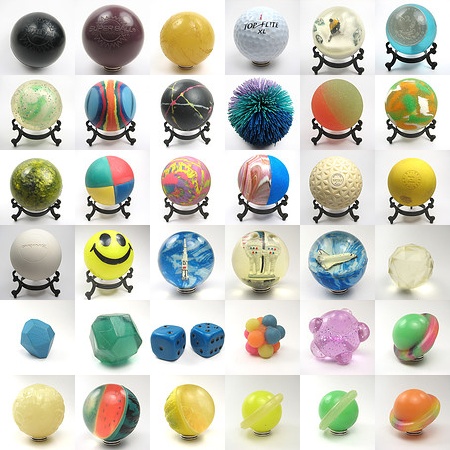 a bunch of different colorful balls and toys