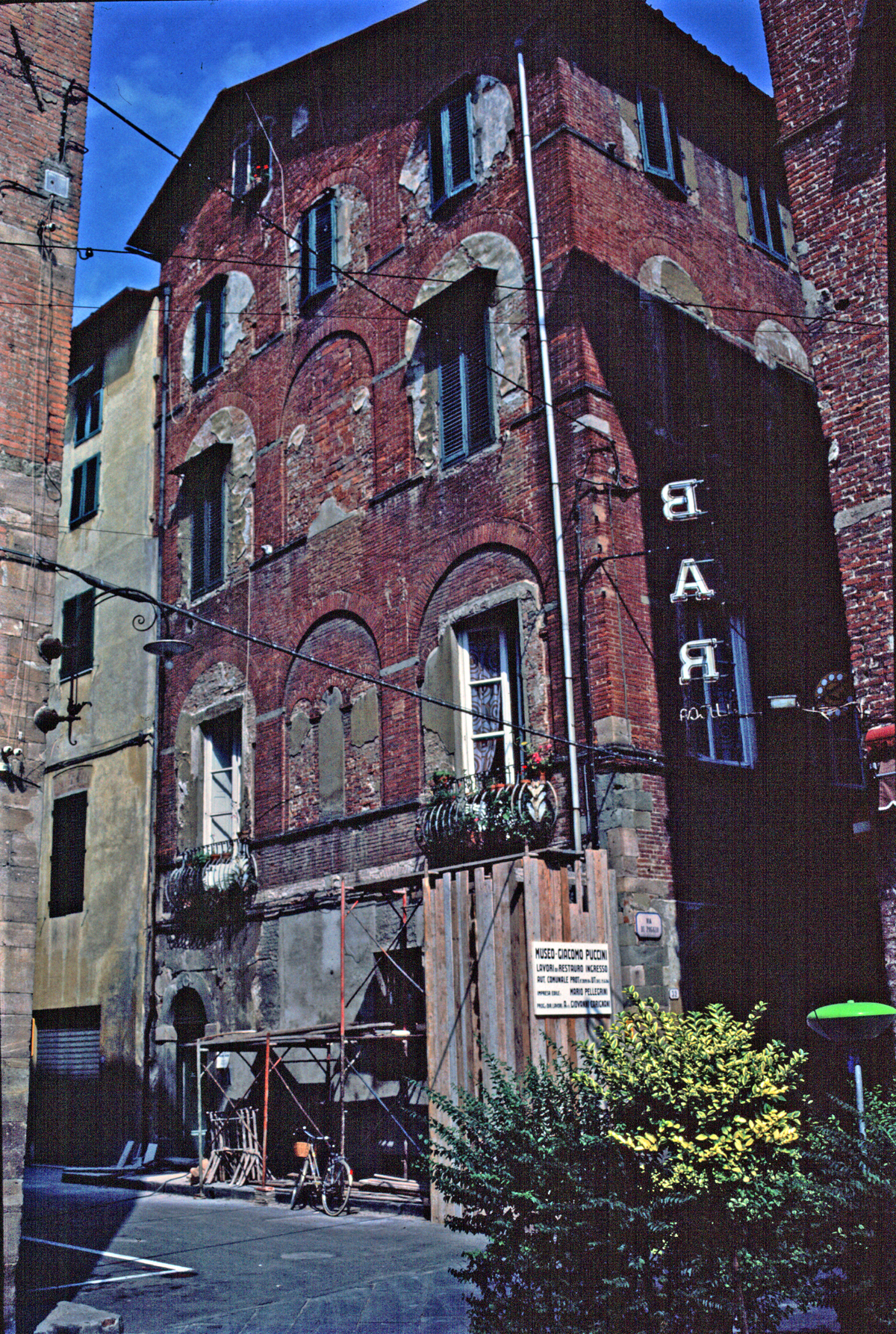 a tall brick building with a sign in the window