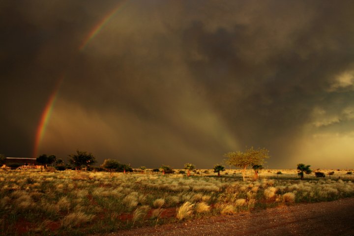 a rainbow seen against a cloudy sky