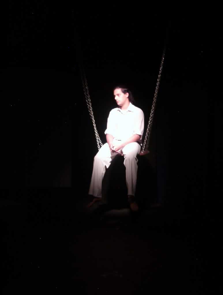 woman sitting on a chair alone in the dark