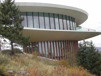 there is a modern building on top of a hill